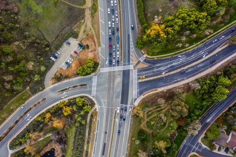 Illustrative overhead photograph of a signalized intersection, turn lanes, and crosswalks
