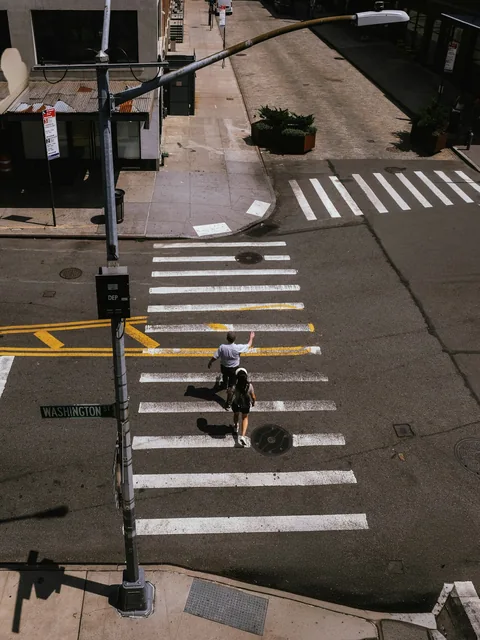 Illustrative photograph of pedestrians using a marked urban crosswalk
